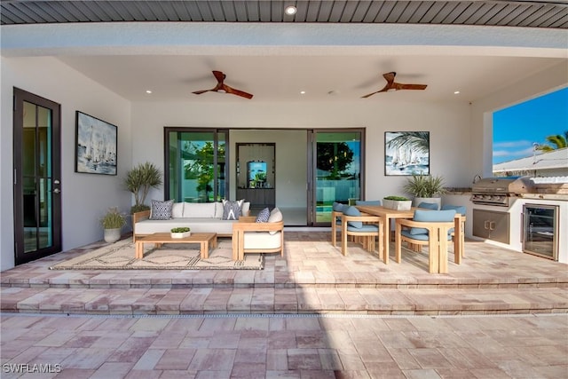 view of patio with ceiling fan, area for grilling, and beverage cooler