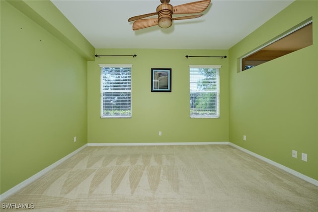 unfurnished room featuring light carpet and ceiling fan