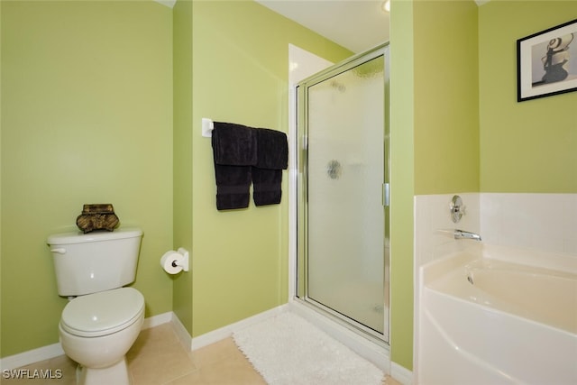 bathroom featuring toilet, shower with separate bathtub, and tile patterned floors