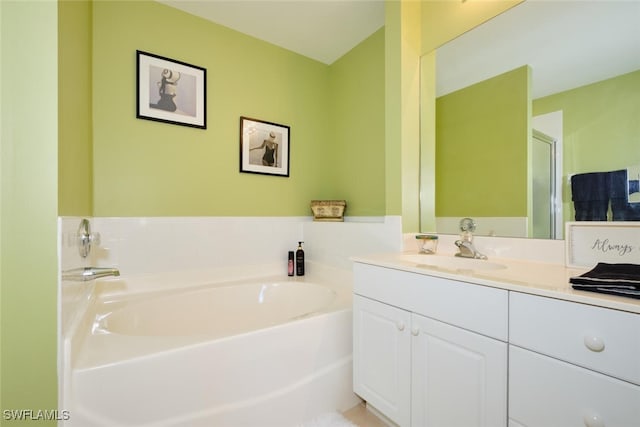 bathroom featuring vanity and a tub