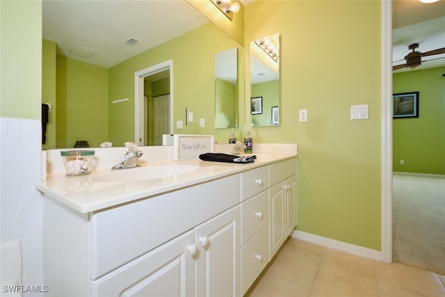 bathroom with tile patterned flooring, vanity, and ceiling fan