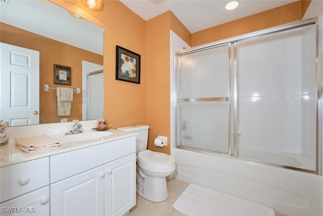 full bathroom featuring tile patterned floors, vanity, bath / shower combo with glass door, and toilet