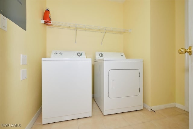 laundry room with light tile patterned flooring and washing machine and dryer