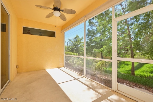 unfurnished sunroom featuring ceiling fan