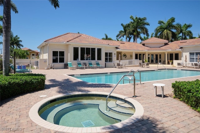 view of swimming pool featuring a patio area and a community hot tub