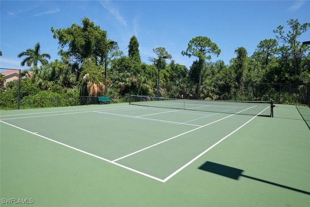 view of tennis court featuring basketball court