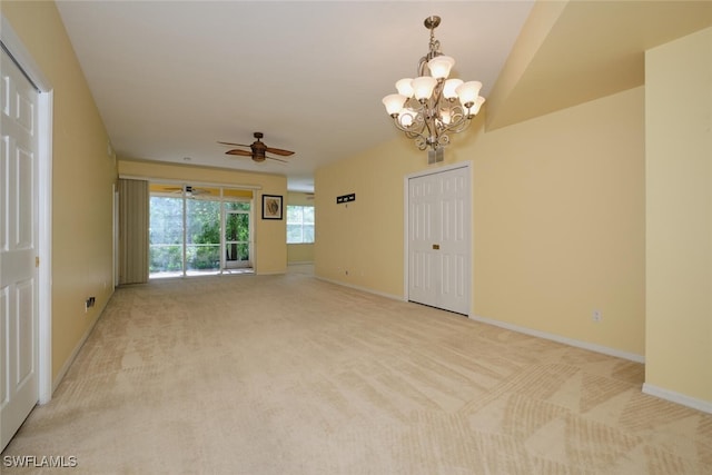 spare room with light colored carpet and ceiling fan with notable chandelier