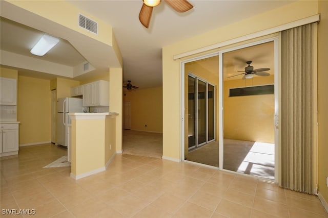 interior space with ceiling fan and light tile patterned floors