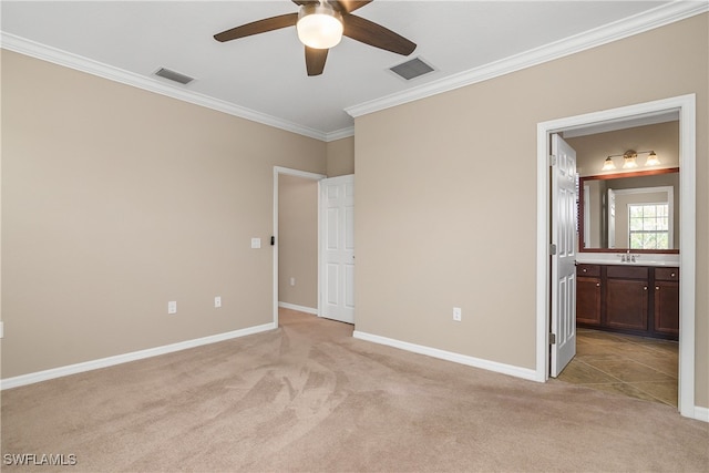 unfurnished bedroom with crown molding, baseboards, visible vents, and light carpet