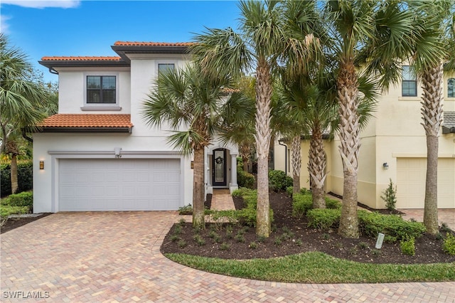 mediterranean / spanish-style house with a garage