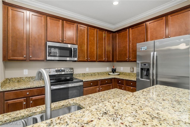 kitchen featuring a sink, light stone countertops, appliances with stainless steel finishes, and crown molding