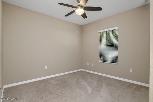 unfurnished room featuring baseboards, carpet, and ceiling fan