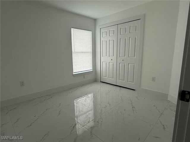 unfurnished bedroom with a closet