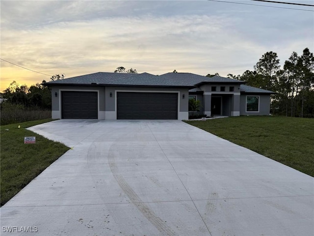 view of front facade with a lawn and a garage