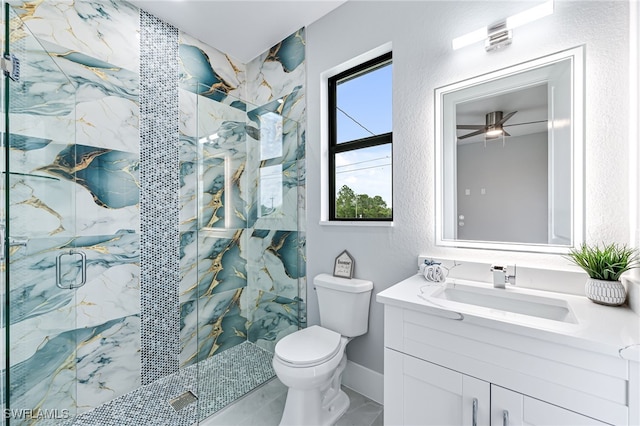 bathroom featuring vanity, toilet, and a shower with door