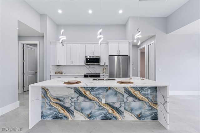 kitchen featuring light stone countertops, sink, backsplash, white cabinets, and appliances with stainless steel finishes