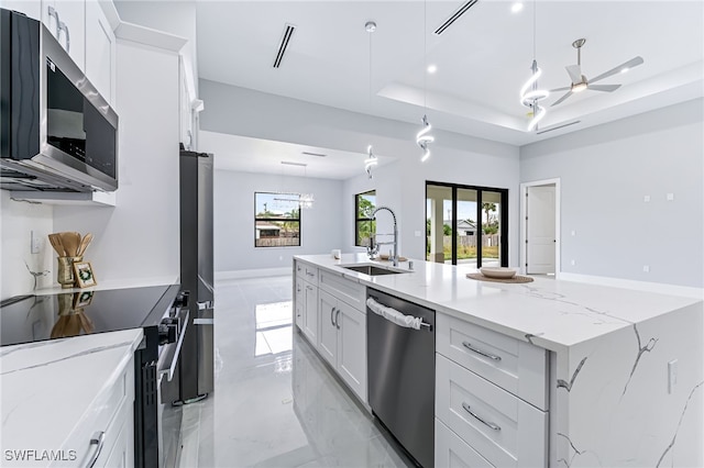 kitchen with white cabinetry, sink, ceiling fan, and stainless steel appliances