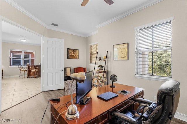 office area featuring ceiling fan, ornamental molding, a wealth of natural light, and light wood-type flooring