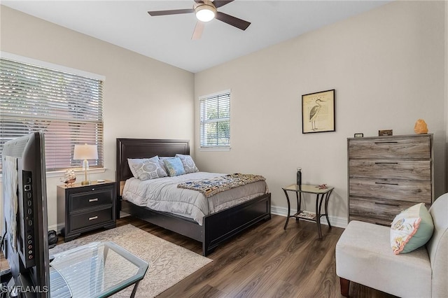 bedroom with ceiling fan and dark hardwood / wood-style floors