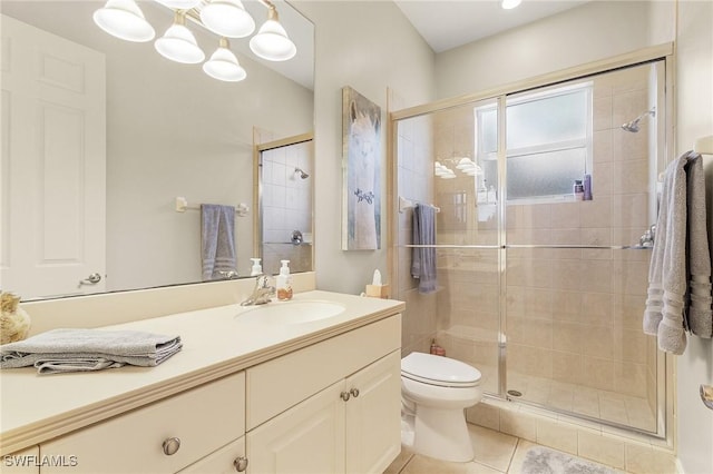 bathroom featuring vanity, tile patterned flooring, toilet, and walk in shower