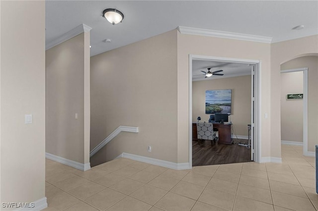 corridor with light tile patterned flooring and crown molding