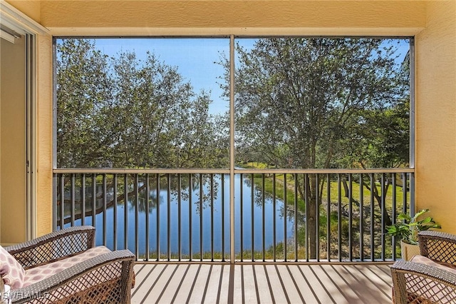 sunroom with a water view and a wealth of natural light