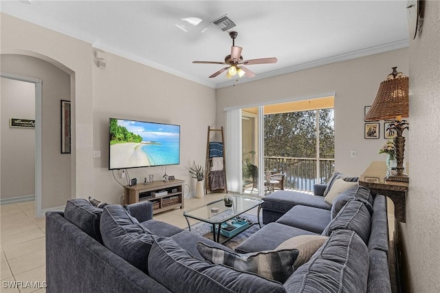 living room with light tile patterned floors, ceiling fan, and crown molding