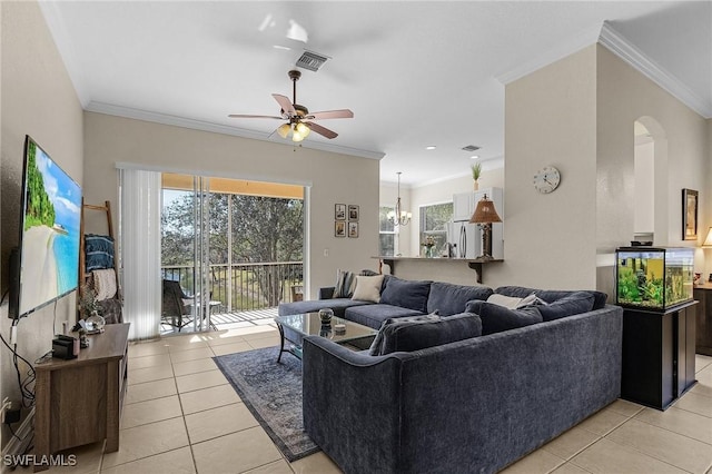 living room featuring ceiling fan with notable chandelier, ornamental molding, and light tile patterned floors