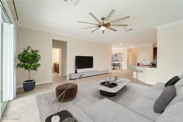 living room featuring ceiling fan, light tile patterned flooring, ornamental molding, and sink