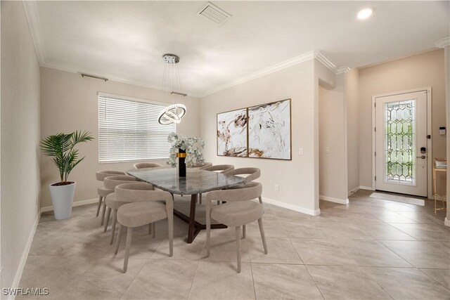 tiled dining area featuring crown molding