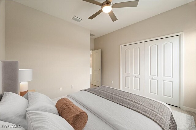 bedroom featuring ceiling fan, a closet, and light colored carpet