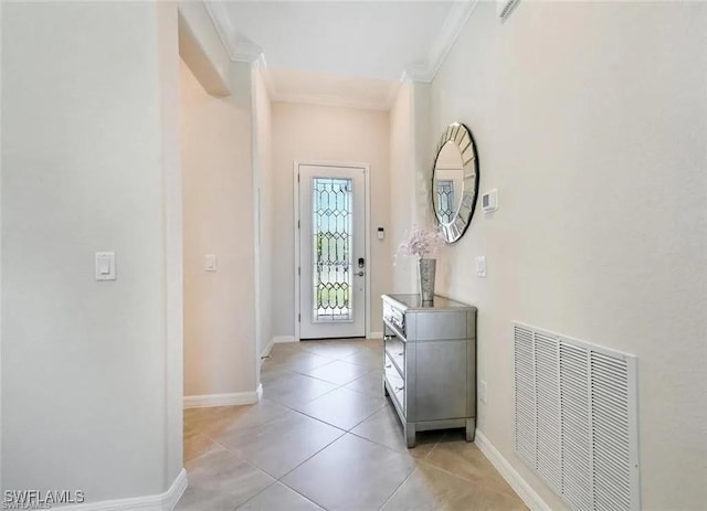 tiled foyer entrance featuring ornamental molding