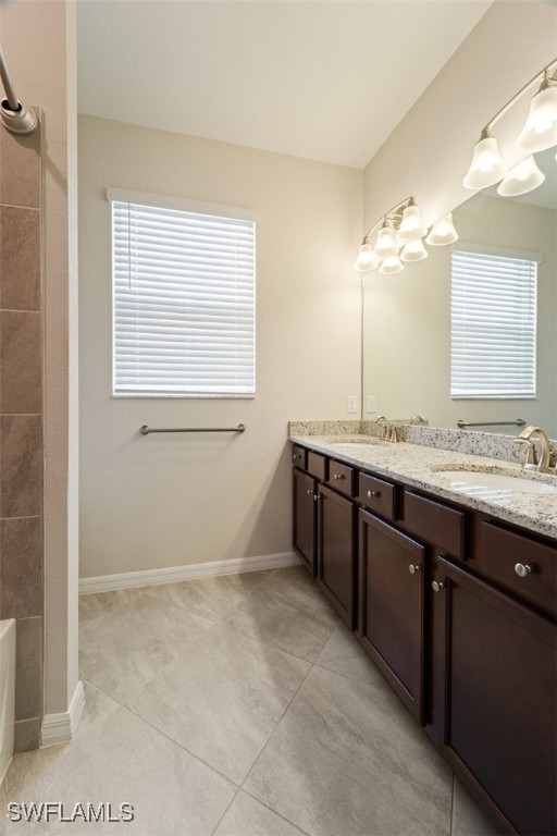 bathroom featuring a bath, vanity, and tile patterned floors