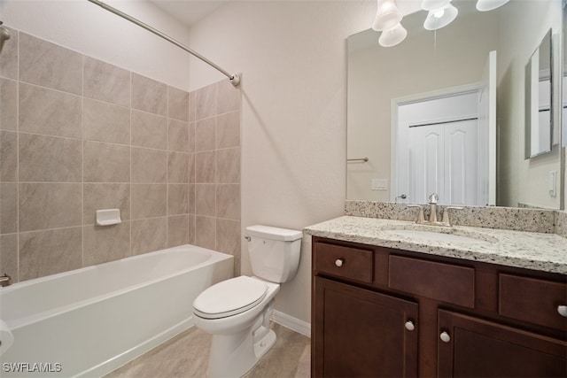 full bathroom with vanity, tiled shower / bath combo, and toilet