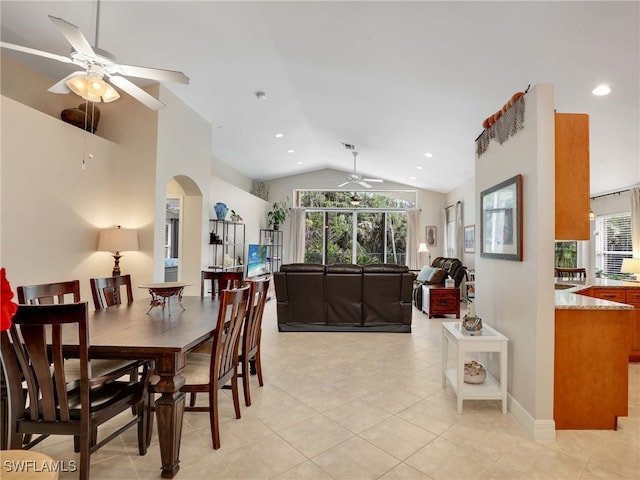 dining area with lofted ceiling, ceiling fan, light tile patterned floors, and a healthy amount of sunlight