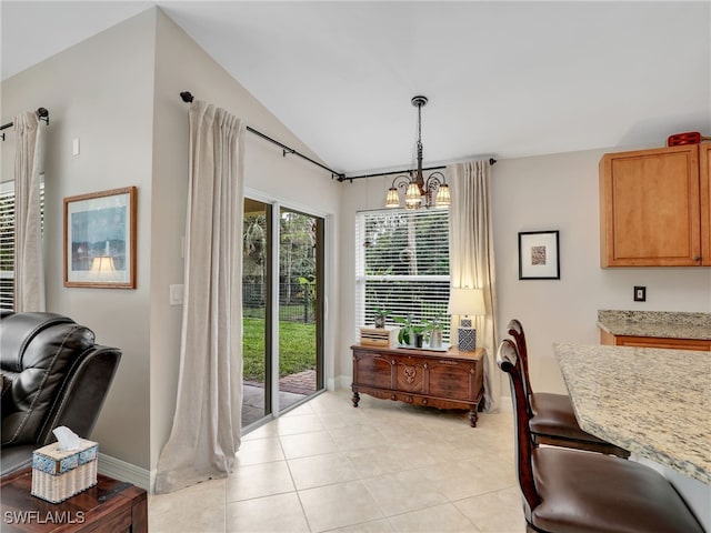 dining area with light tile patterned flooring, lofted ceiling, and an inviting chandelier