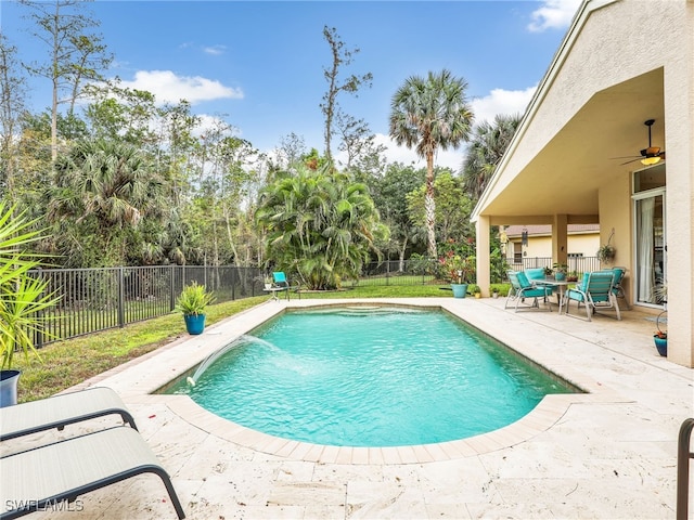 view of swimming pool featuring pool water feature, a patio, and ceiling fan