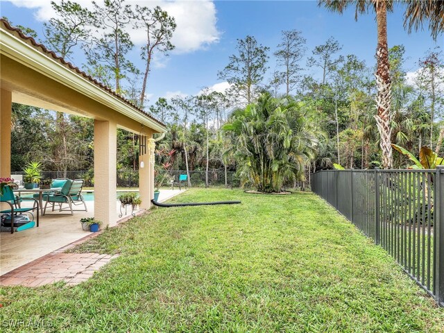 view of yard with a patio area, a fenced in pool, and a fenced backyard