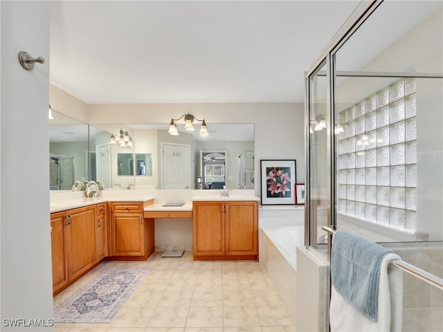 bathroom featuring independent shower and bath, vanity, and tile patterned floors