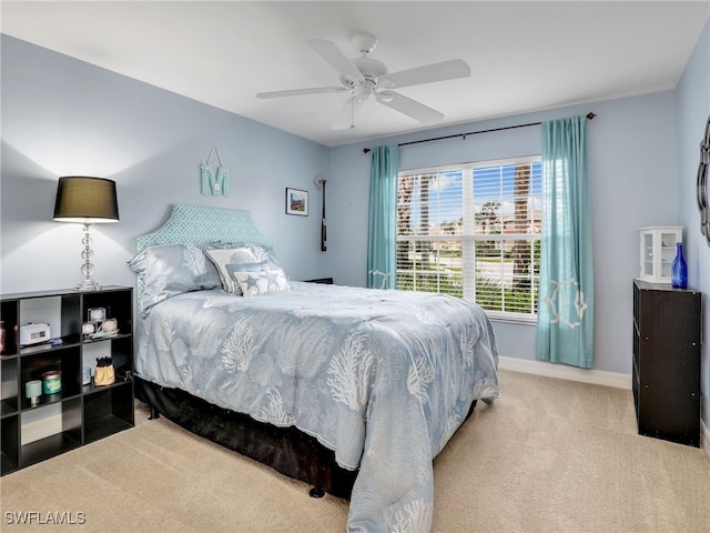 bedroom featuring light carpet and ceiling fan