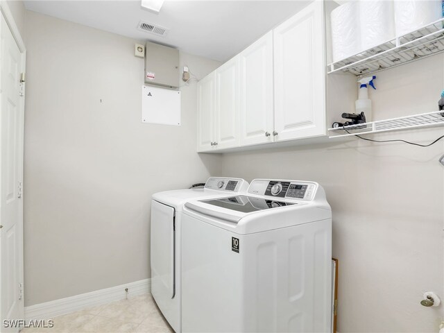 laundry room with light tile patterned flooring, cabinet space, baseboards, visible vents, and independent washer and dryer