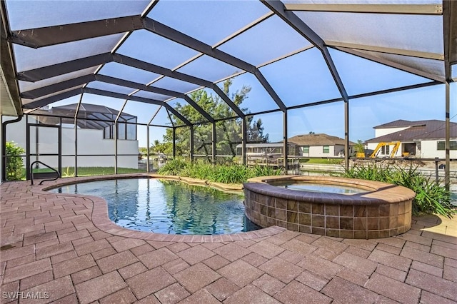 view of swimming pool with a lanai, an in ground hot tub, and a patio