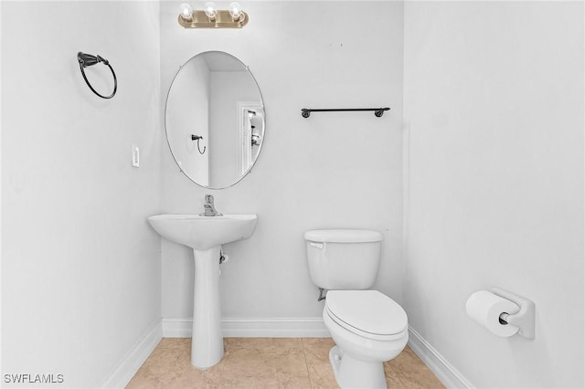 bathroom with tile patterned floors and toilet