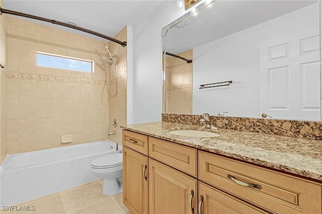 full bathroom featuring toilet, vanity, tiled shower / bath combo, and tile patterned floors