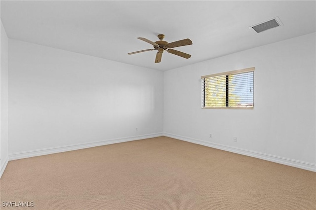 empty room with ceiling fan and light colored carpet