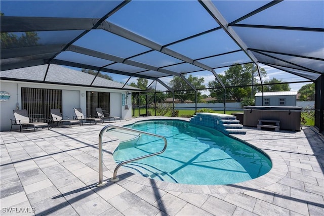 view of swimming pool featuring a lanai, a patio area, and a hot tub