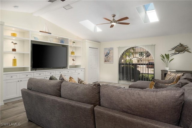 living room featuring ceiling fan, built in features, lofted ceiling with beams, and wood-type flooring