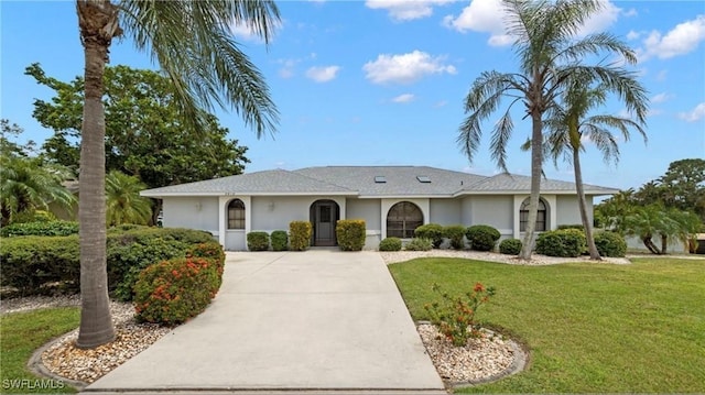 single story home featuring a front lawn