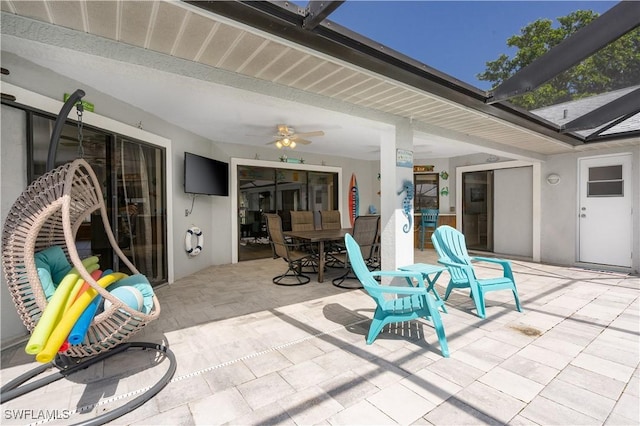 view of patio / terrace featuring glass enclosure and ceiling fan