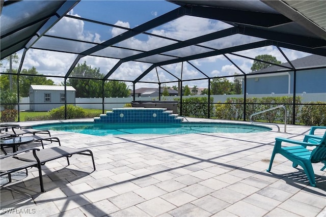 view of pool with glass enclosure and a patio